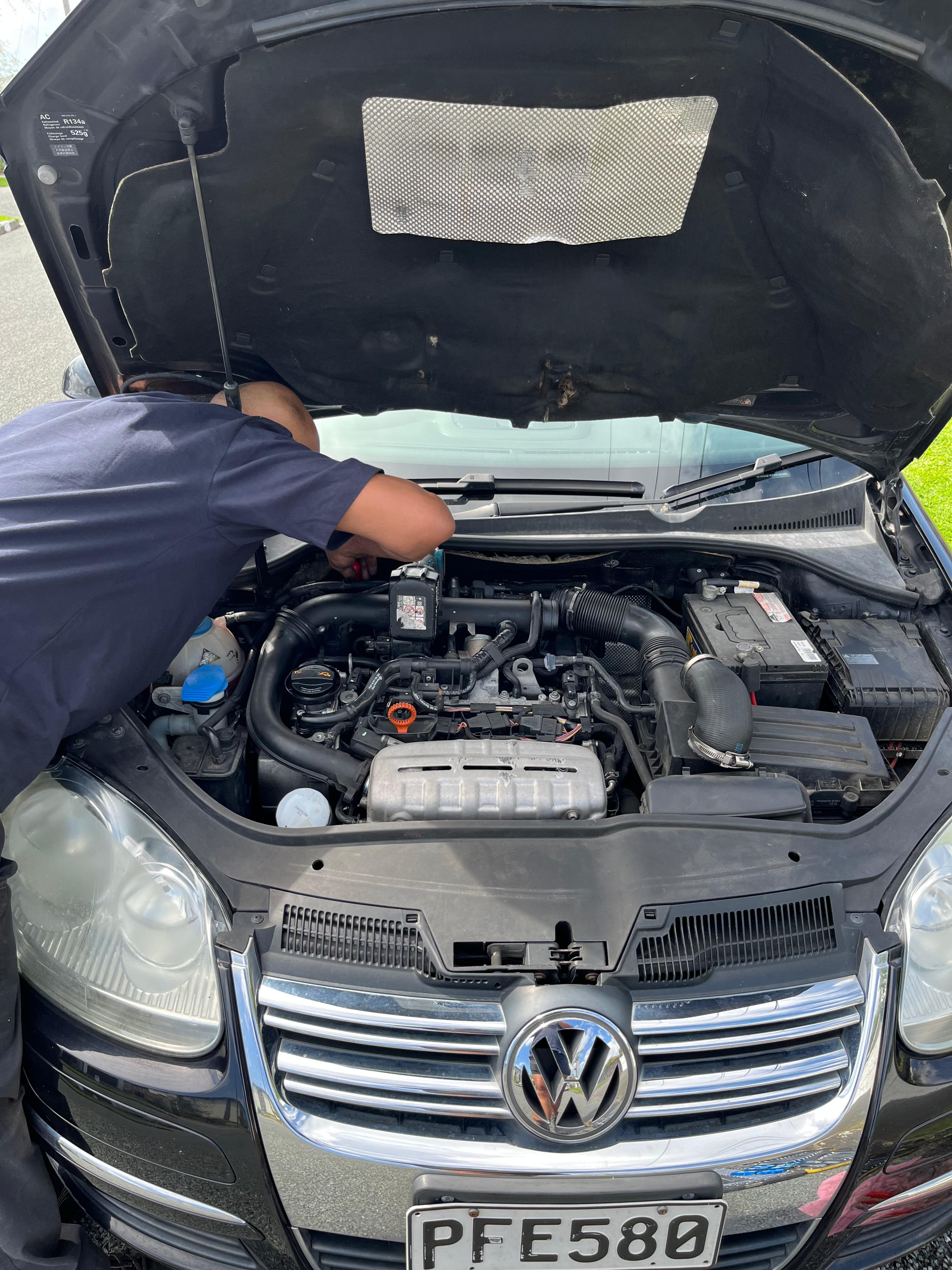 Mobile mechanic servicing a Volkswagen engine in Auckland